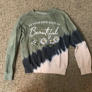 A crew neck sweater it is a dark green, black, and cream color.